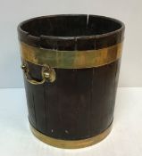 A Georgian mahogany and brass bound peat bucket with twin brass handles 40.