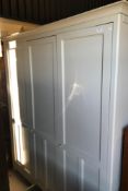 A painted Shaker style three door wardrobe,