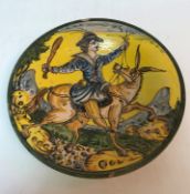 A 19th Century Italian majolica dish, the centre decorated with gentleman with club on mule,