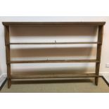 A 20th Century pine dresser, the plain top above three drawers and two cupboard doors,