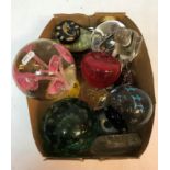 A collection of various paperweights etc to include Victorian green glass dump style weight with