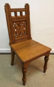 A late Victorian Gothic oak hall chair by Lamb of Manchester,