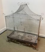 A vintage wirework and wrought iron framed birdcage with scrollwork decoration,