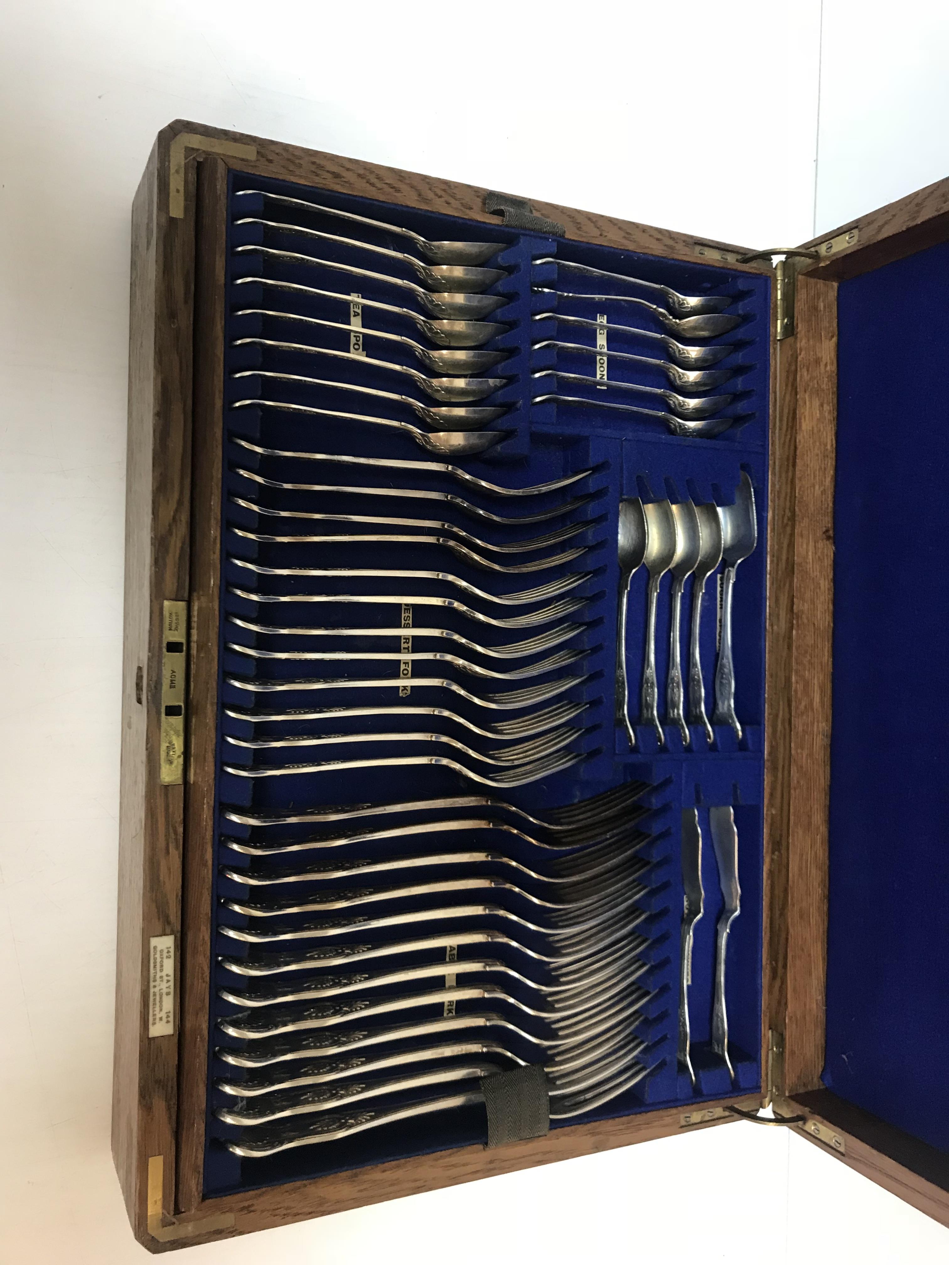 An Edwardian oak canteen of silver kings pattern cutlery comprising eight table forks,