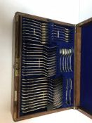 An Edwardian oak canteen of silver kings pattern cutlery comprising eight table forks,