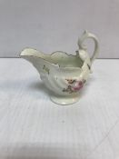 A late 18th Century Derby type Rococo porcelain cream jug of shell decorated helmet form,