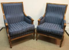 A pair of modern oak framed upholstered armchairs in the Regency style,