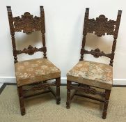 A pair of late 19th Century Continental carved walnut framed bar back dining chairs with scrolling