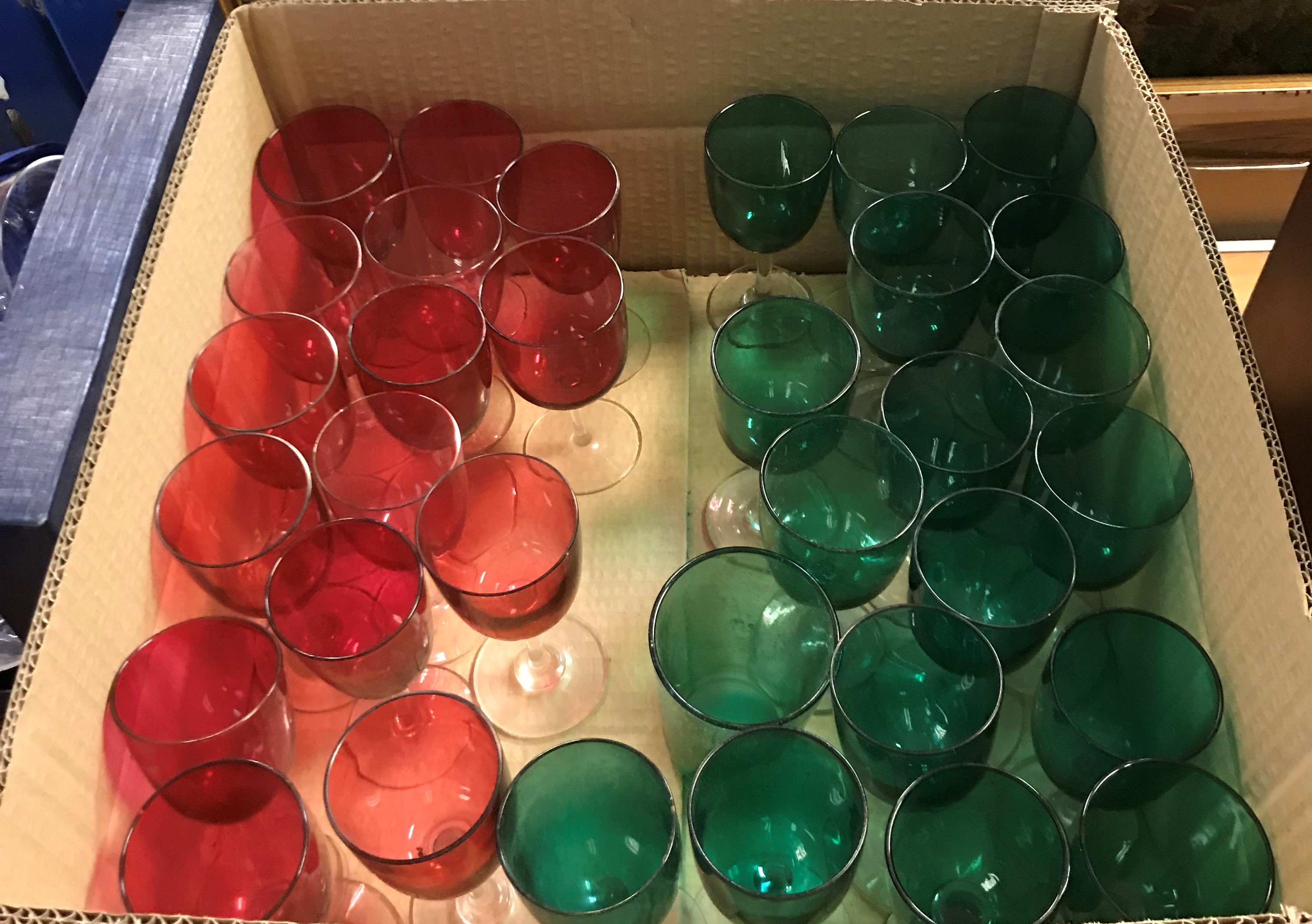 A collection of seventeen 20th Century Bristol green glass stemmed drinking glasses on clear stems,