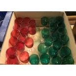 A collection of seventeen 20th Century Bristol green glass stemmed drinking glasses on clear stems,