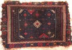 A Kurdish tribal rug, the central panel set with blue,