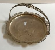 A silver basket with pierced handles and edges raised on a circular foot (by E.S.