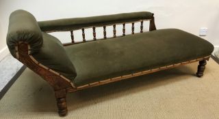 A Victorian walnut framed chaise longue with galleried back and Aesthetic style carved decorated