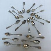 A collection of early 19th Century and later silver tea spoons of fiddle pattern with various dates