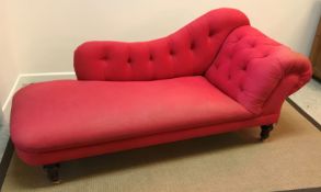 A Victorian buttoned upholstered scroll end chaise longue on turned and ringed mahogany legs to