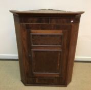 A 19th Century North Country oak and inlaid hanging corner cupboard 90 cm wide x 103 cm high,