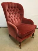 A modern Parker Knoll button back armchair in the Victorian style raised on stained and turned