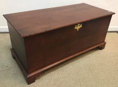 An American cherry wood coffer in the 18th Century style raised on bracket feet bearing brass