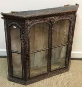 A 19th Century stained and carved pine display cabinet in the 17th Century Continental manner with