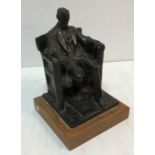 A glazed terracotta figure of Abraham Lincoln seated in large armchair inscribed "DC French June
