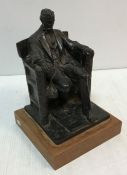 A glazed terracotta figure of Abraham Lincoln seated in large armchair inscribed "DC French June