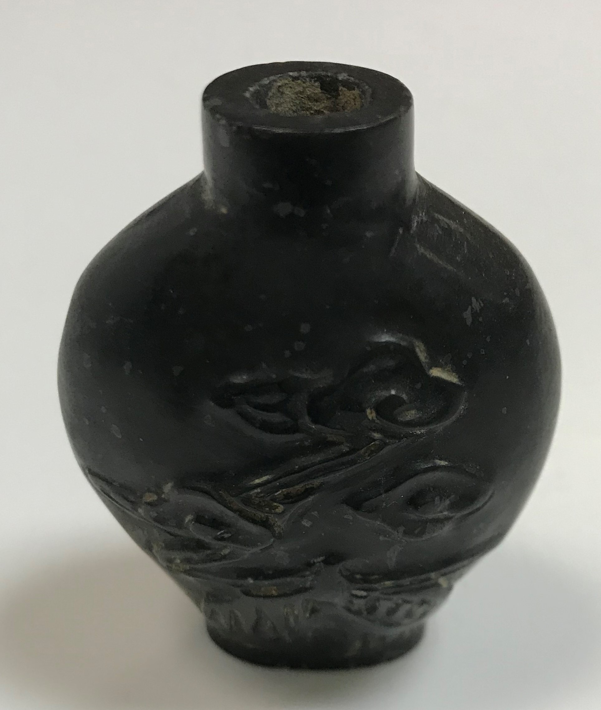 A carved pale jade snuff bottle of flask form, 6 cm x 4 cm,