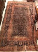 A Persian rug, the central panel set with all-over foliate decoration on a blue ground,