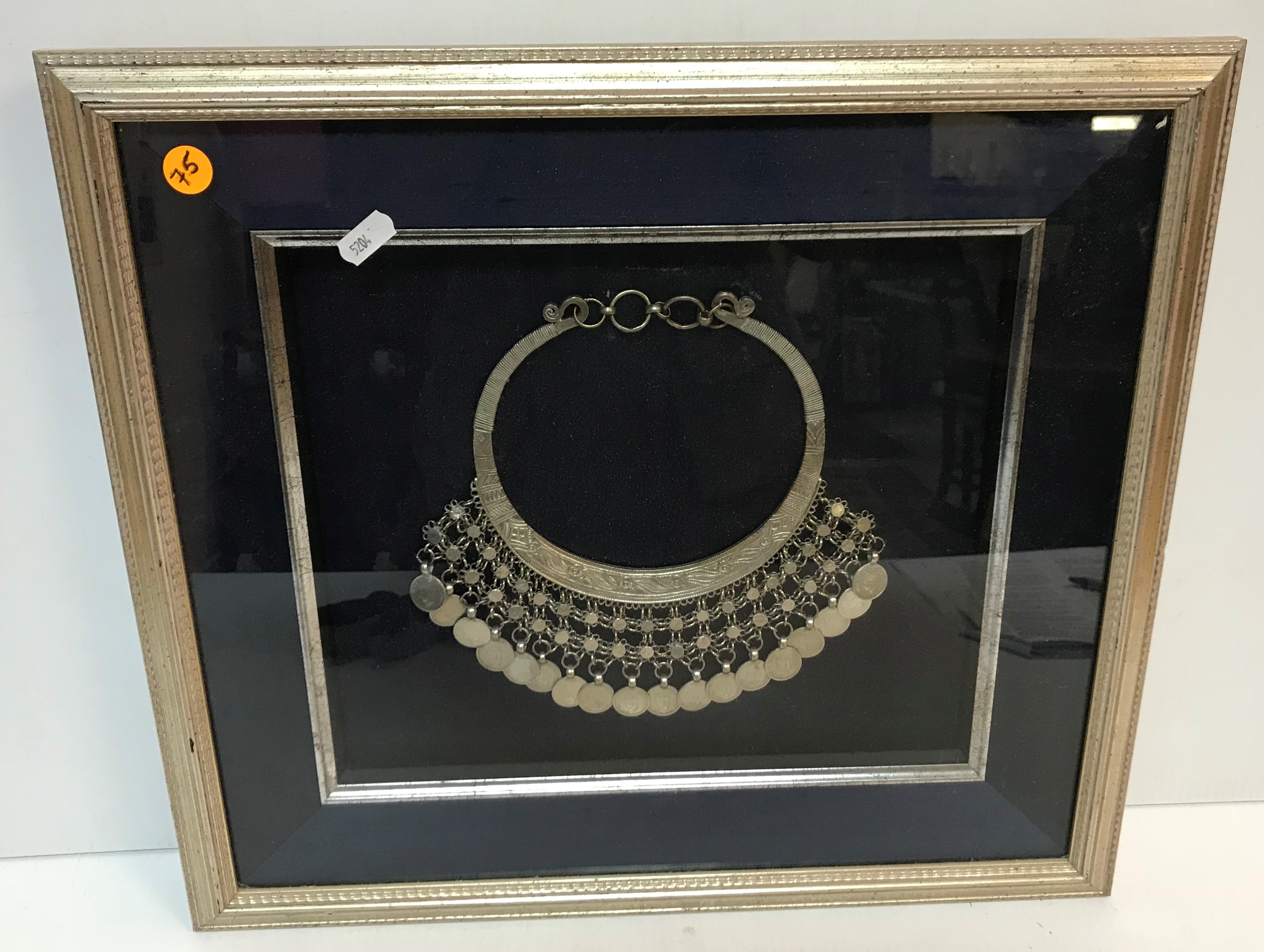 A Tibetan white metal necklet set with coins, 22 cm wide x 20 cm high,