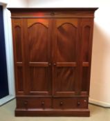 A modern mahogany double wardrobe with two drawer base 148 cm wide x 57 cm deep x 197.