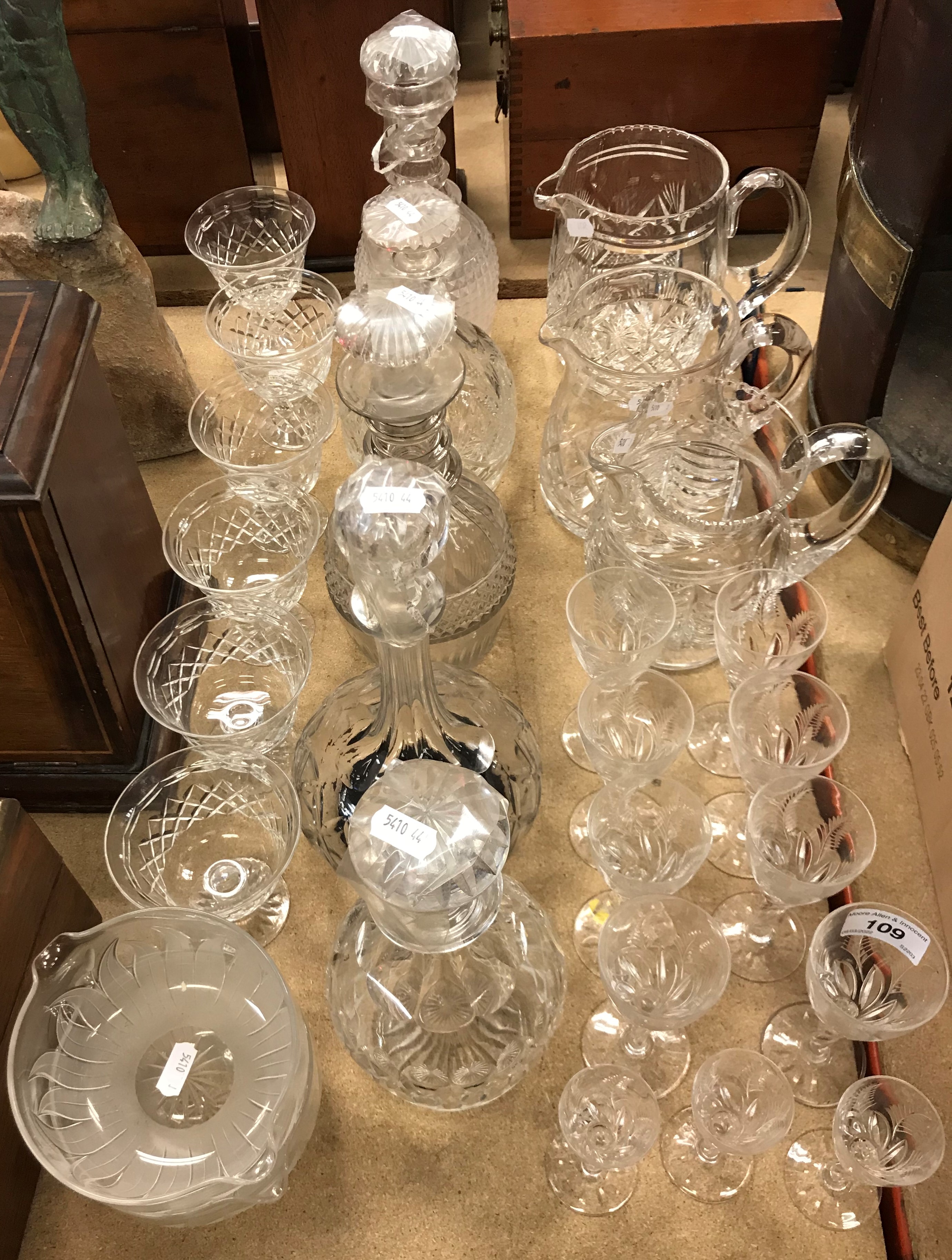 A collection of glassware to include five various cut glass decanters, a pair of rinsers,