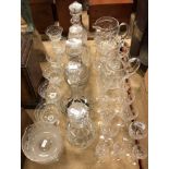 A collection of glassware to include five various cut glass decanters, a pair of rinsers,