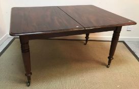 A mahogany extending dining table, the r