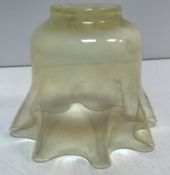 A vaseline glass lampshade with frilled