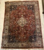 A Persian rug, the central panel set wit