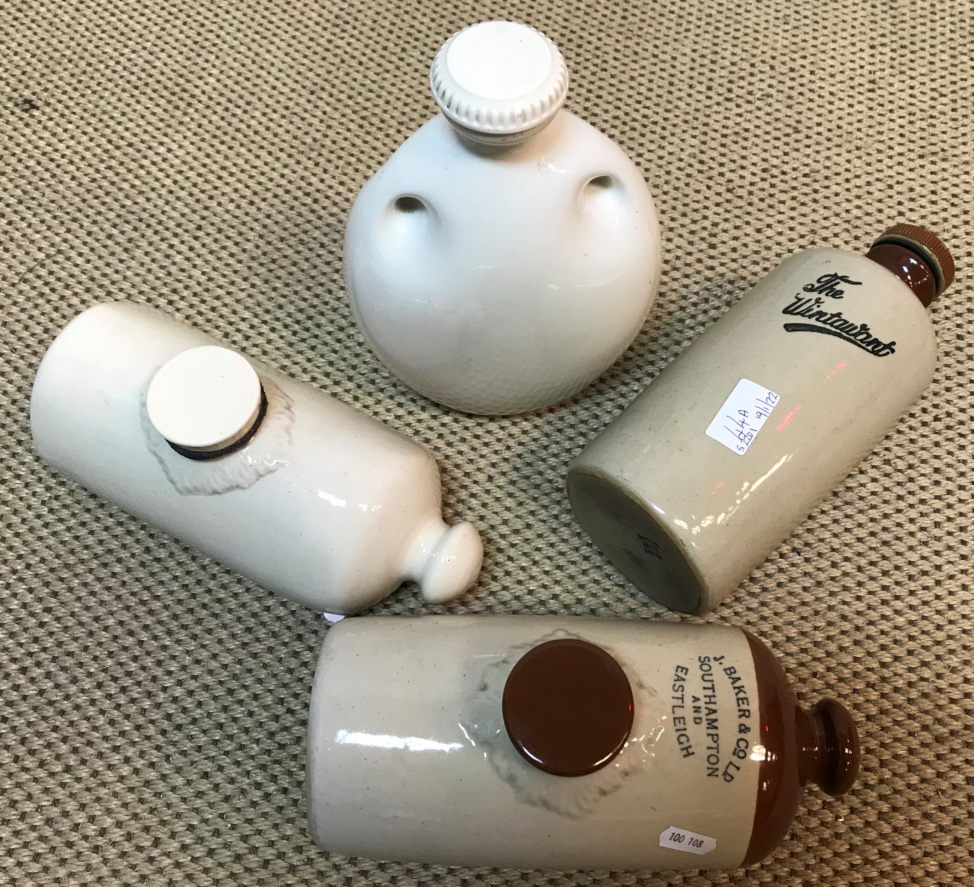 A collection of four stoneware hot water