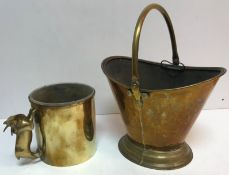 A brass coal bucket of boat form raised