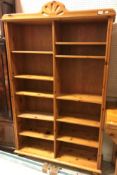 A modern pine open bookcase of two banks