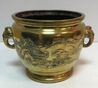 A Japanese brass twin handled jardiniere