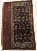 A Bokhara rug, the main panel set with f