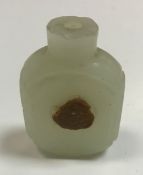 A Chinese carved pale jade snuff bottle