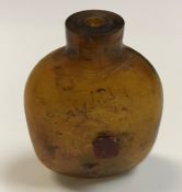 A Chinese amber glass scent bottle with