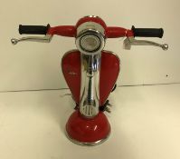 A red scooter table lamp, inscribed "Ves