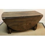 An oak oval double gate-leg drop-leaf di