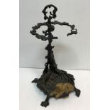 A cast iron painted stick stand set with