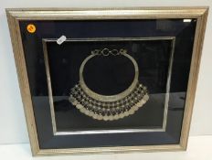 A Tibetan white metal necklet set with c