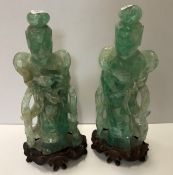 A pair of Chinese green quartz figures of Guanyin with flower, 26.