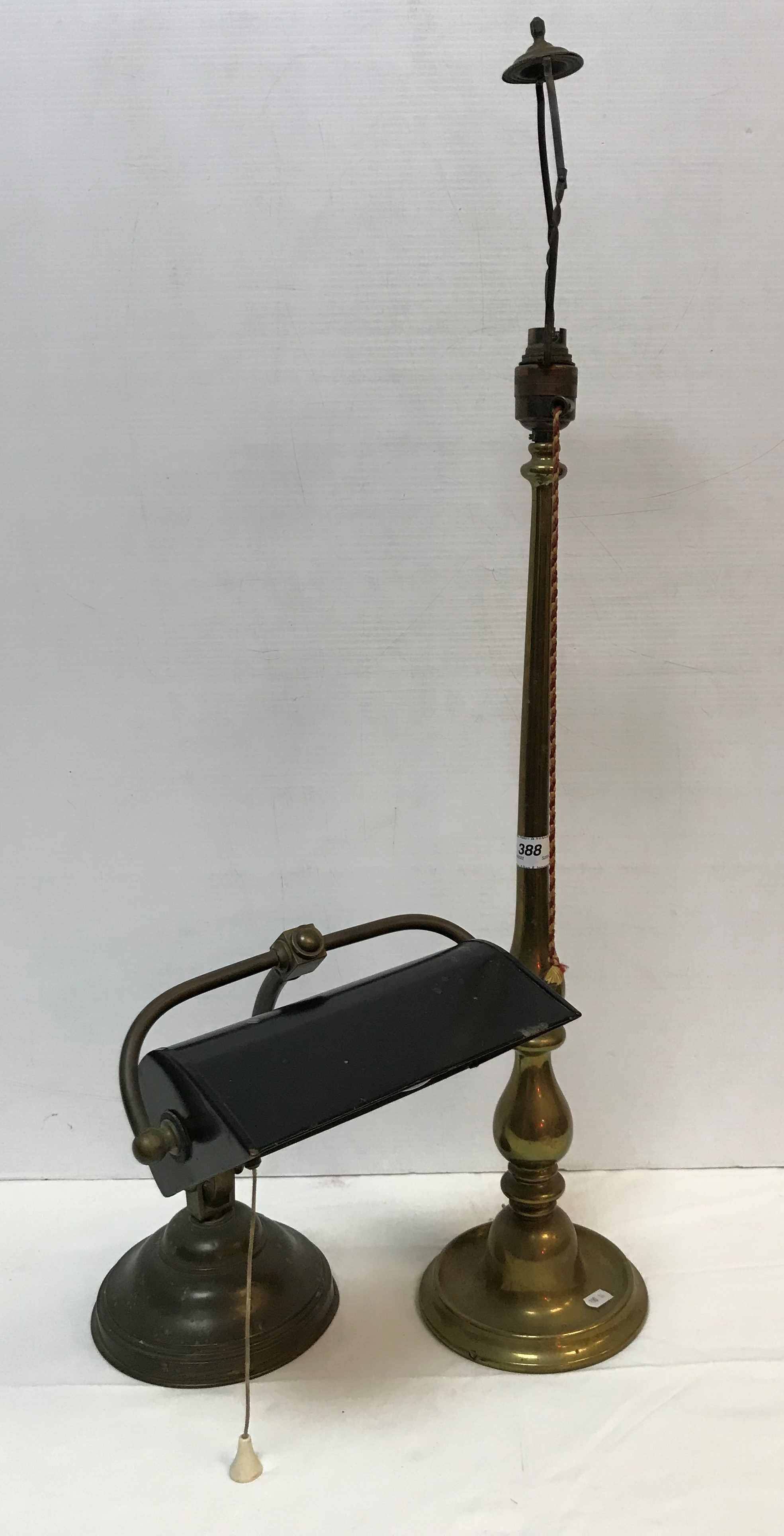 A circa 1900 brass and painted tin desk lamp of typical form and a brass baluster shaped table lamp