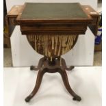 A 19th Century rosewood and cross-banded games / work table with reading slope top enclosing a