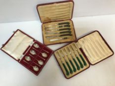 A cased set of six George V silver pronged forks with jade coloured pistol grip handles by