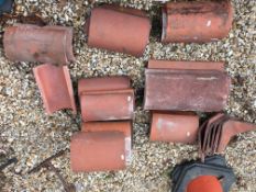 A collection of nineteen various ridge tiles together with other tiles including slates etc,